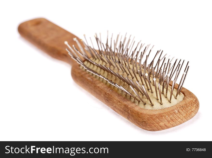 Old comb with wooden handle isolated on the white background. Used and dusty. Narrow depth of field. Old comb with wooden handle isolated on the white background. Used and dusty. Narrow depth of field.