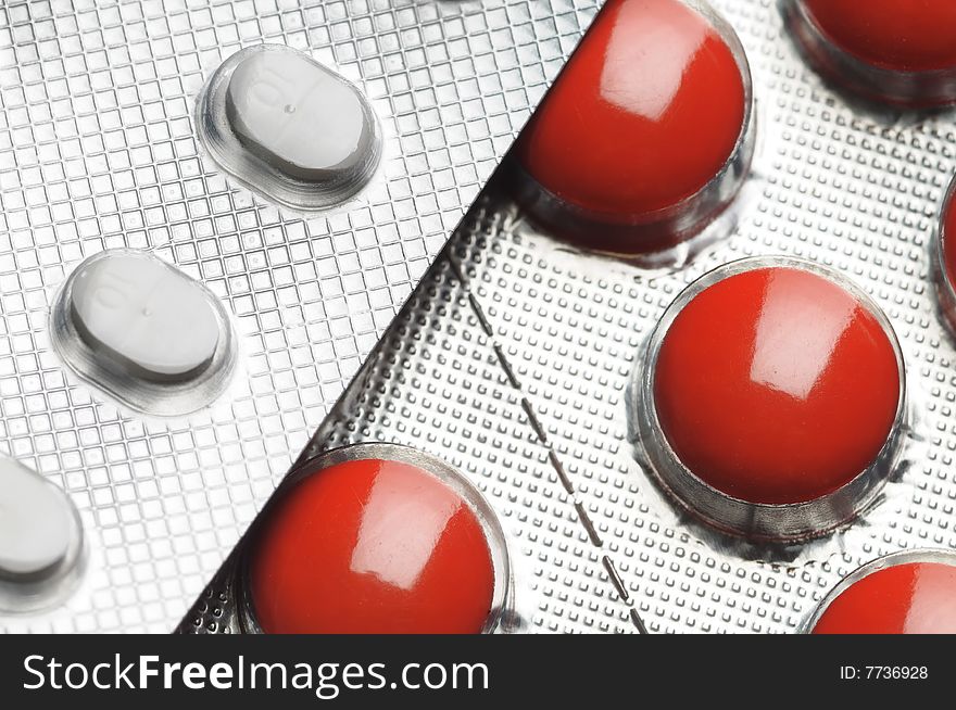 Red and white tablets. Close-up. Narrow depth of field. Red and white tablets. Close-up. Narrow depth of field.