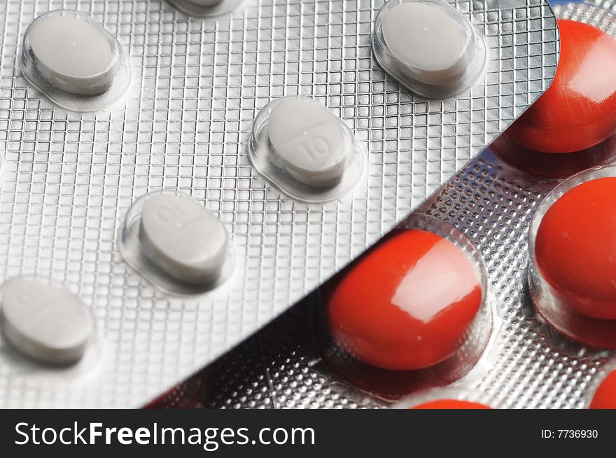 Red and white tablets. Close-up. Narrow depth of field. Red and white tablets. Close-up. Narrow depth of field.