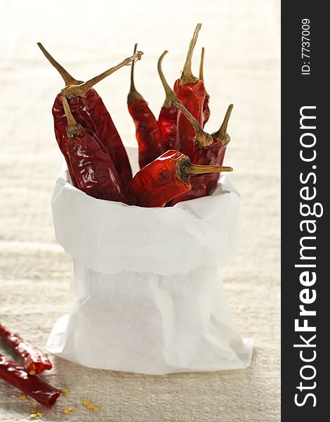 Dried chili, hot and spicy ingredient herb, in a paper bag. Dried chili, hot and spicy ingredient herb, in a paper bag.