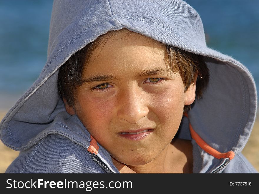 Boy with hooded shirt posing