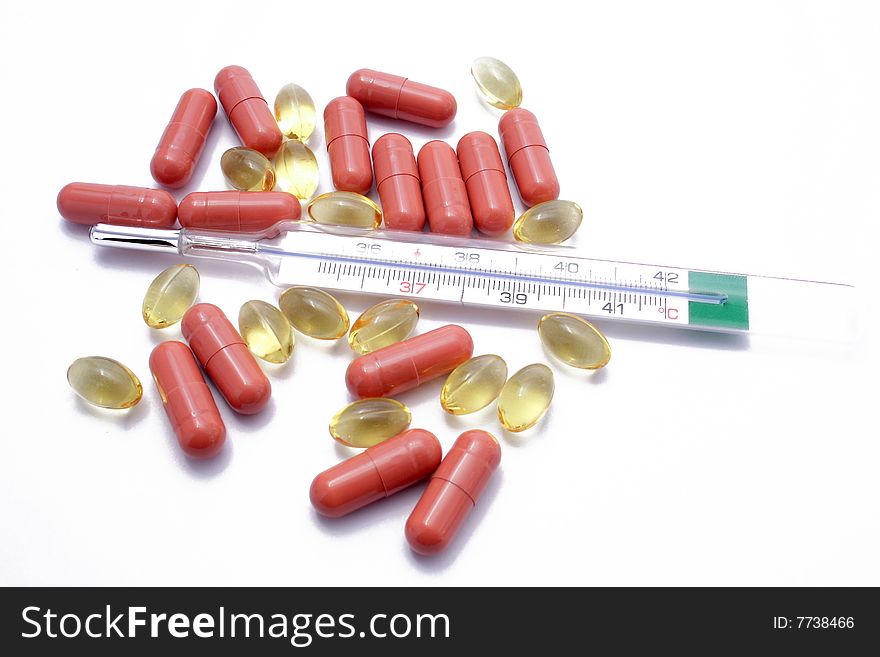 Yellow and brown pills with thermometer