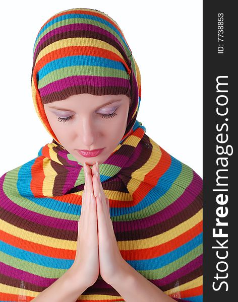 Young beautiful woman in a  striped sweater is praying