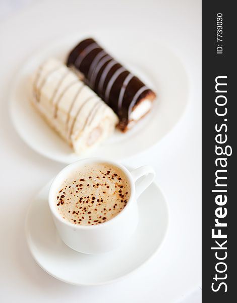 Coffee or cappuccino with chocolate cakes on white. Coffee or cappuccino with chocolate cakes on white