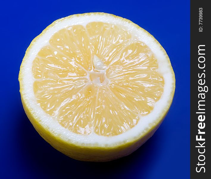 Half of lemon on blue background