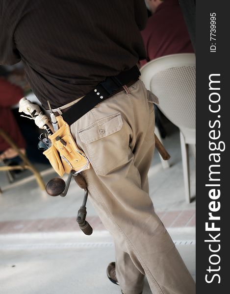 Man wearing a tool belt with tools. Man wearing a tool belt with tools