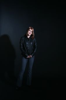 Teenage Girl In Black Leather Jacket Smiling Stock Photo