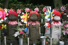 Japanese Doll Statues With Red Hats And Windmills Royalty Free Stock Photo Japanese Doll Statues With Red Hats And Windmills Royalty Free Stock Photo