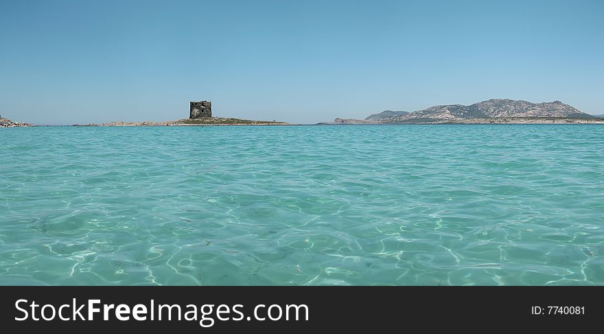 Panoramic view of La Pelosa beach in Sardinia (Italy). Picture stitched from multiple photos. Panoramic view of La Pelosa beach in Sardinia (Italy). Picture stitched from multiple photos.