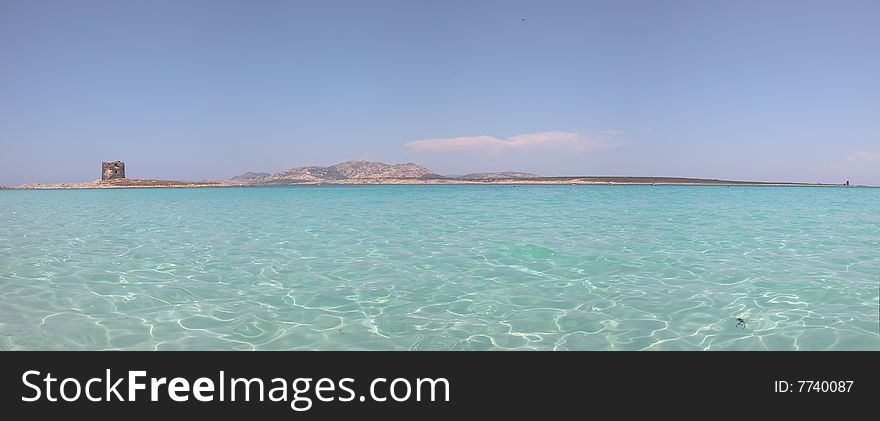 Panoramic view of La Pelosa beach in Sardinia (Italy). Picture stitched from multiple photos. Panoramic view of La Pelosa beach in Sardinia (Italy). Picture stitched from multiple photos.