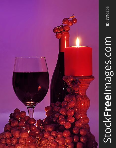 Wine and grapes in candle light. Wine and grapes in candle light