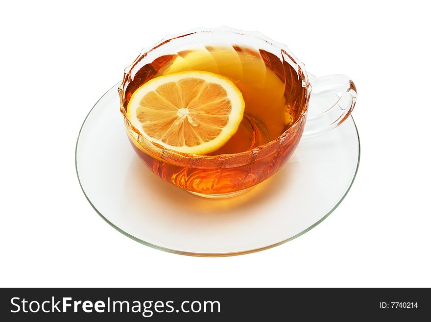 Glass cup with tea and a lemon on a white background