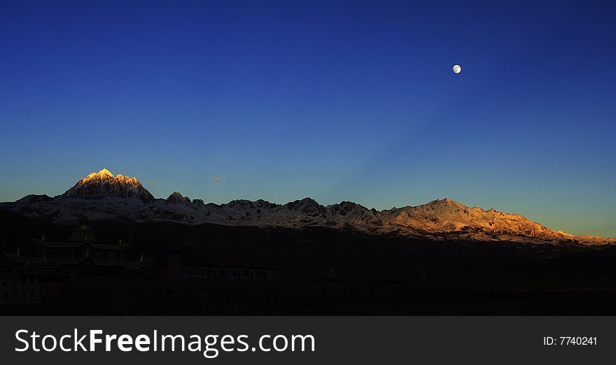 Sunset and moon rise at eve moment, the snow mountain view which called RiZhao JinShan. Sunset and moon rise at eve moment, the snow mountain view which called RiZhao JinShan