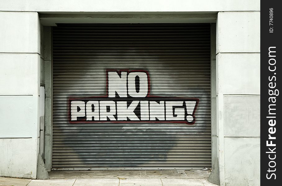 No Parking Sign on Garage Door in Urban Area