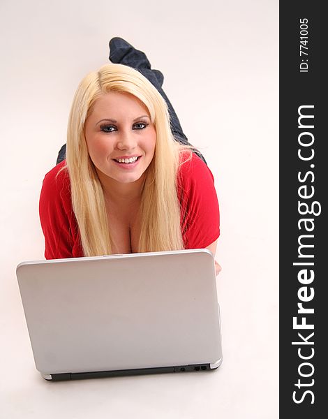 A blond young woman with a laptop. A blond young woman with a laptop