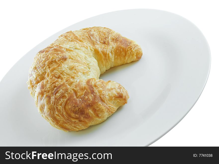 Croissant on plate isolated on white background