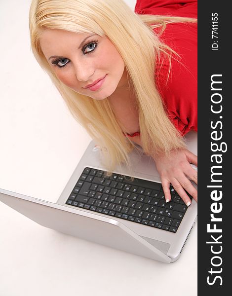 A blond young woman with a laptop. A blond young woman with a laptop