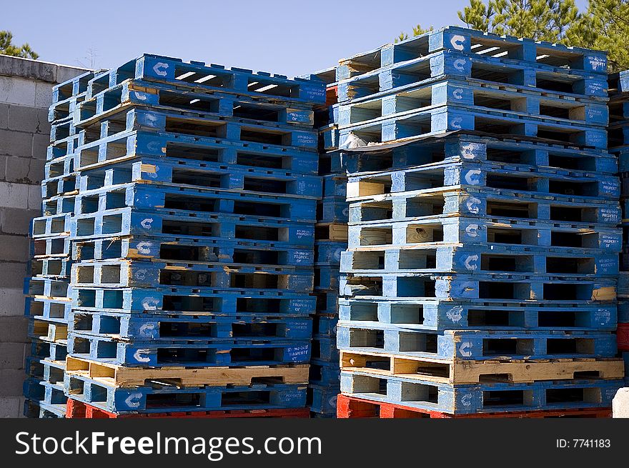Stacked wooden freight pallets for shipping. Stacked wooden freight pallets for shipping.