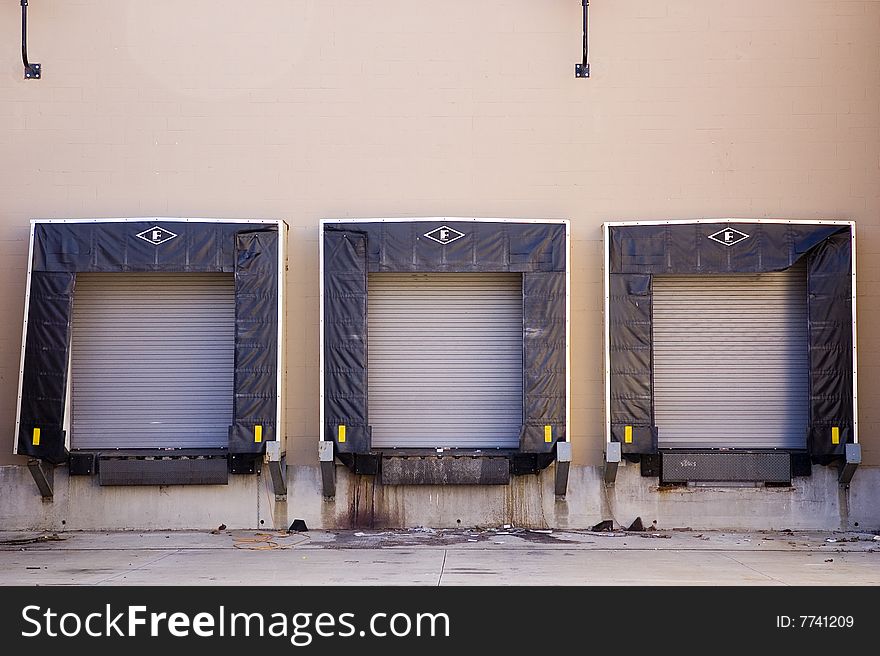 Three empty shipping bays in the back of a  building.