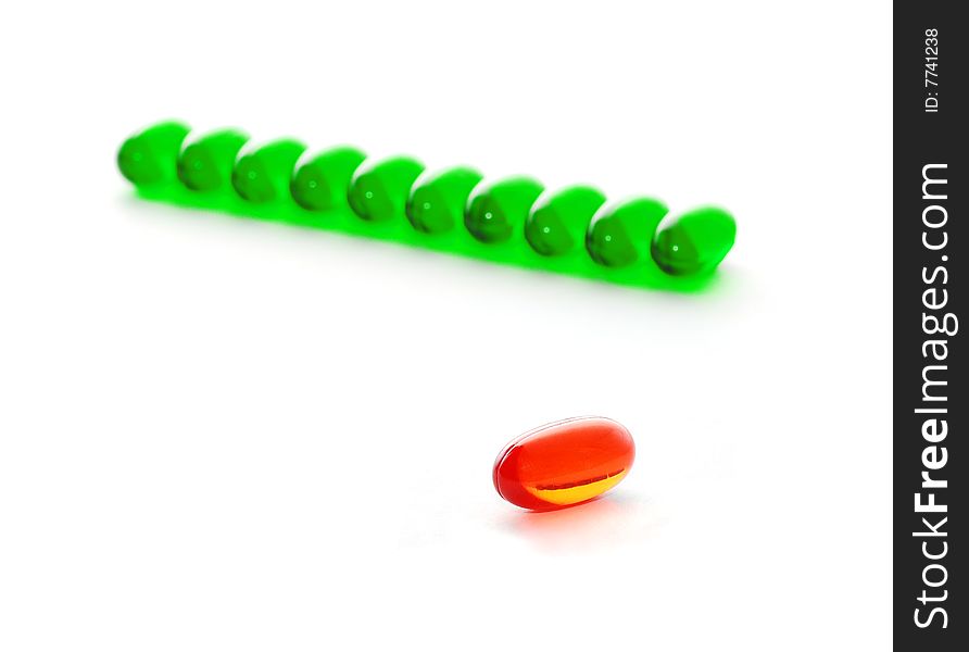 Single red pill and many green pills in a row