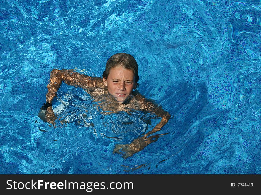 Swimming boy in a pool on vacation