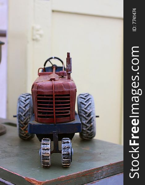 A antique toy tractor in an antique shop.