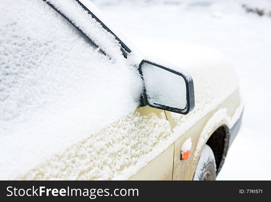 The car filled up by snow. Mirror with snow