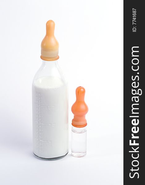 Bottle of the milk and small one with water with nipples on white background. Bottle of the milk and small one with water with nipples on white background