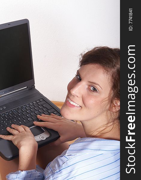 A young woman at home sitting on the floor with her laptop. Lots of copyspace on the laptop screen. A young woman at home sitting on the floor with her laptop. Lots of copyspace on the laptop screen.