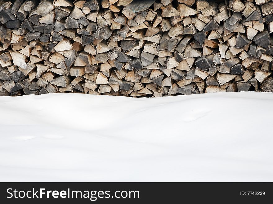 Woodpile after snowing. Copy space