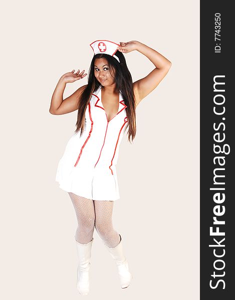 Young Asian woman with long black hair and white fish net stockings
and boots in a nurse uniform on light gray background. Young Asian woman with long black hair and white fish net stockings
and boots in a nurse uniform on light gray background.