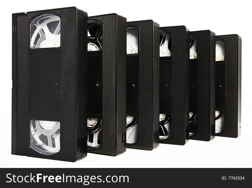 Several black VHS video cassettes on white background. Several black VHS video cassettes on white background