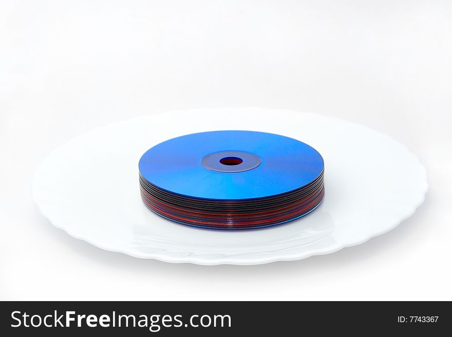 Tasty multimedia technologies: color dvd bundle on white plate