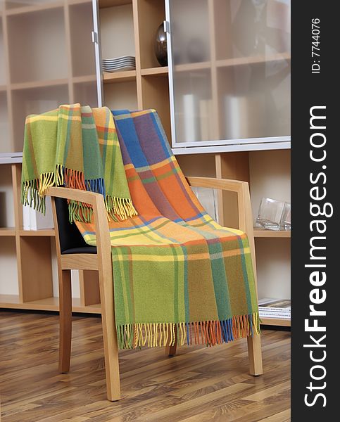 Colorful plaid draped over a chair