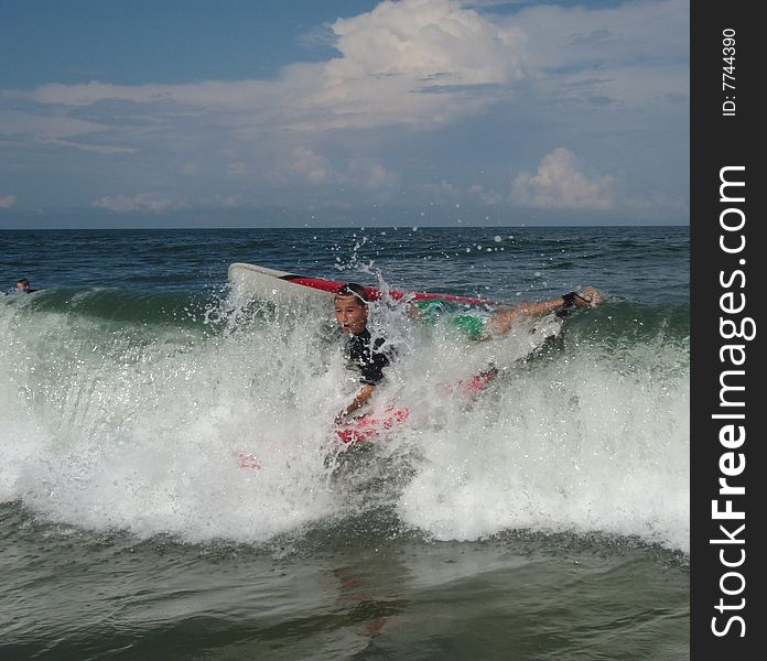 Youth teen boy wiping out in a wave. Youth teen boy wiping out in a wave