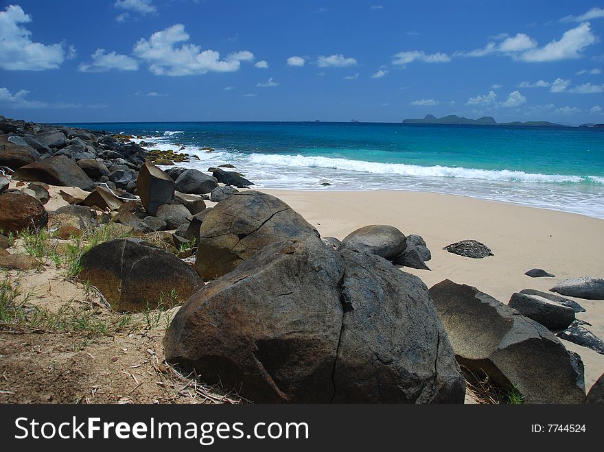 Volcanic rocks on tropical beach. Volcanic rocks on tropical beach