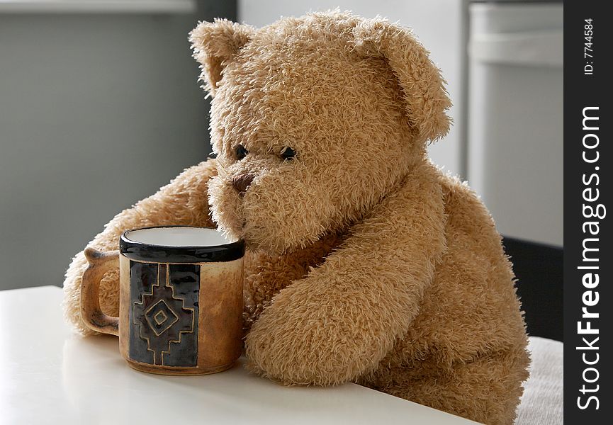 Teddy bear with an empty cup. Teddy bear with an empty cup