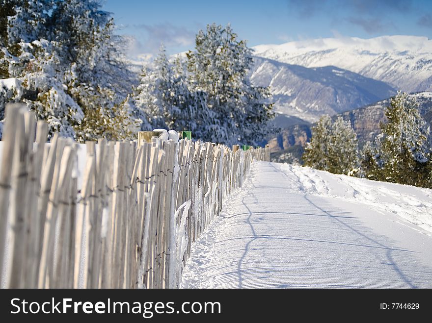 Meadow covered with snow with wooden fence. Meadow covered with snow with wooden fence.