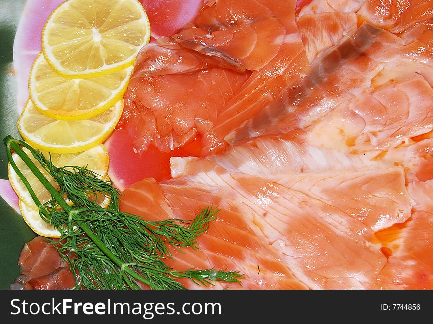 The salmon with lemon, are cut by slices