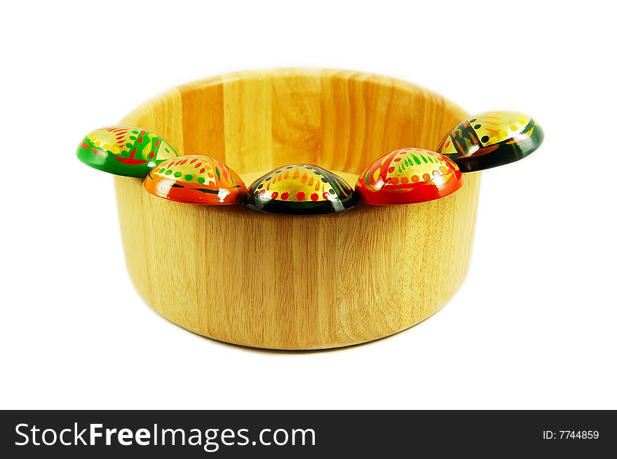 Set of russian wooden spoons on wooden bowl isolated on white