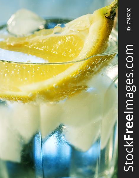 Close-up of Water glass with lemon and ice