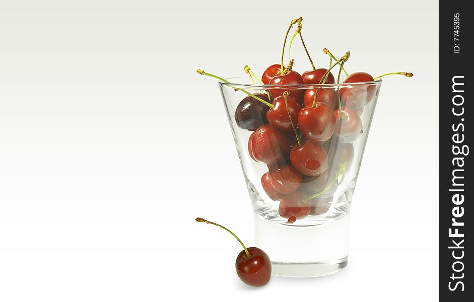 Cherry in glass on white background