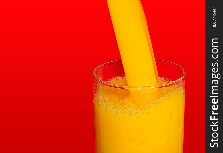 Pouring fresh orange juice in the glass