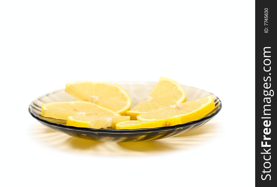 Lemon slices on plate isolated on white