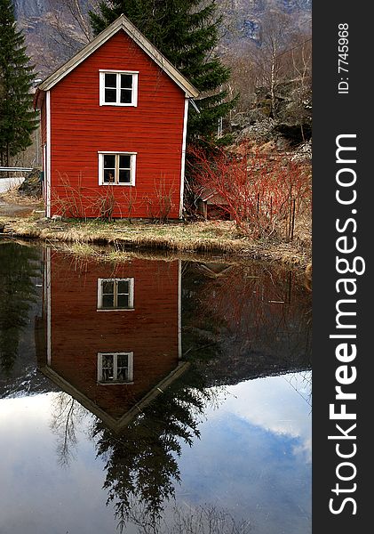 Norway rural scape traditional house and reflection in water