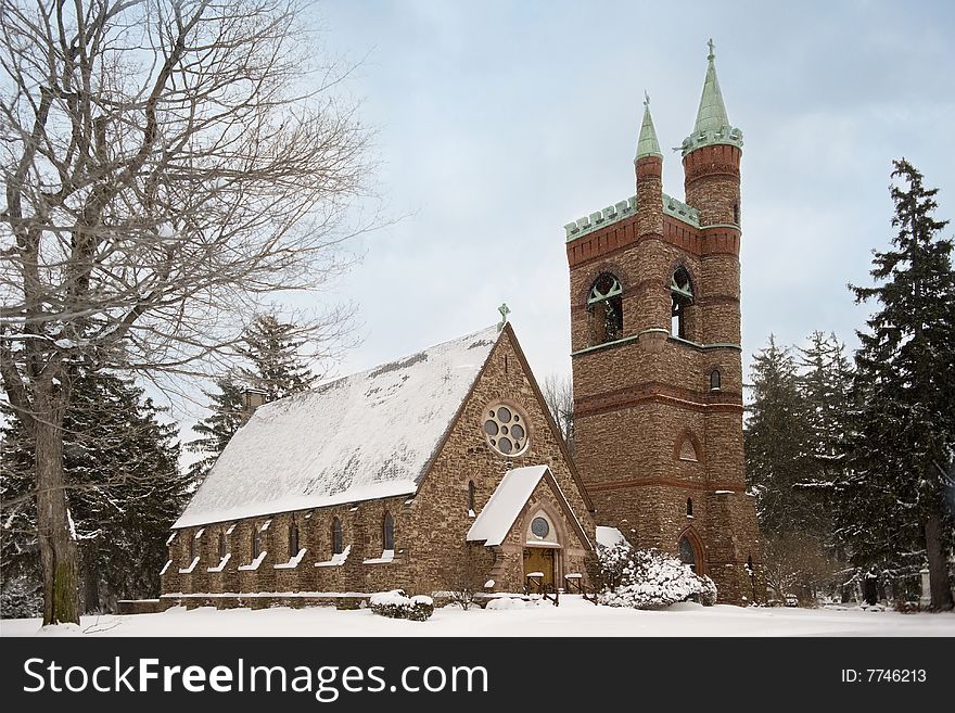 The exterior of a beautiful stone church after a fresh snow. The exterior of a beautiful stone church after a fresh snow.