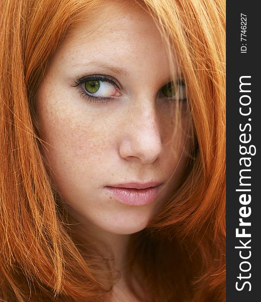 Sensual portrait of beautiful girl with long red hair