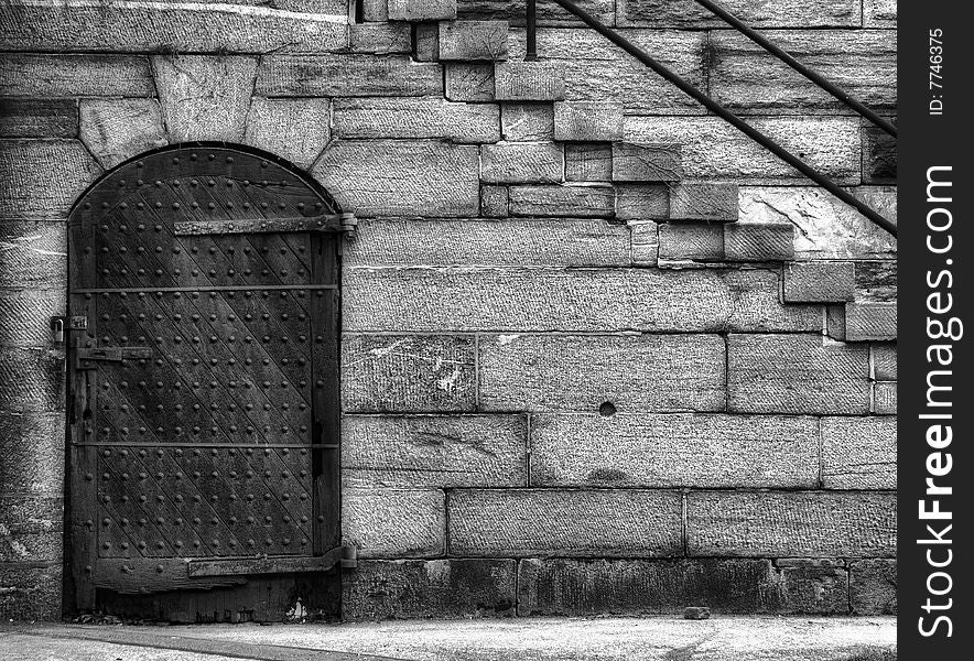 Historical fortress door and steps in black and white.