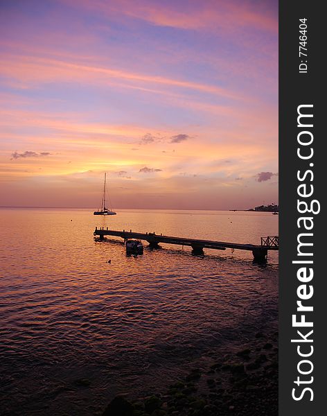 Tropical sunset with pier and boat. Tropical sunset with pier and boat