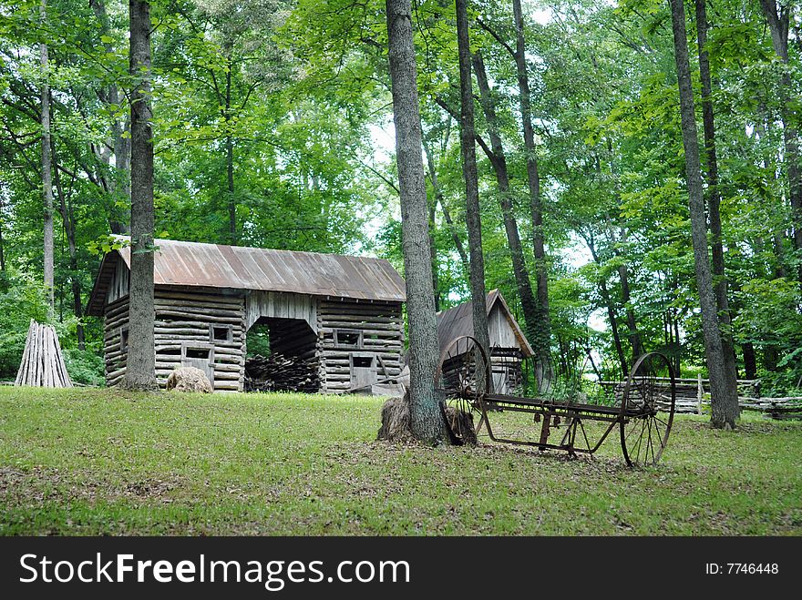 A weathered old barn surrounded by trees. A weathered old barn surrounded by trees.